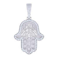 The Moissanite Hamsa Symbol Charm Pendant is crafted from 925 sterling silver and features a gemstone-encrusted eye, engraved symmetrical patterns, and a sparkling gemstone-studded bail for an elegant touch.