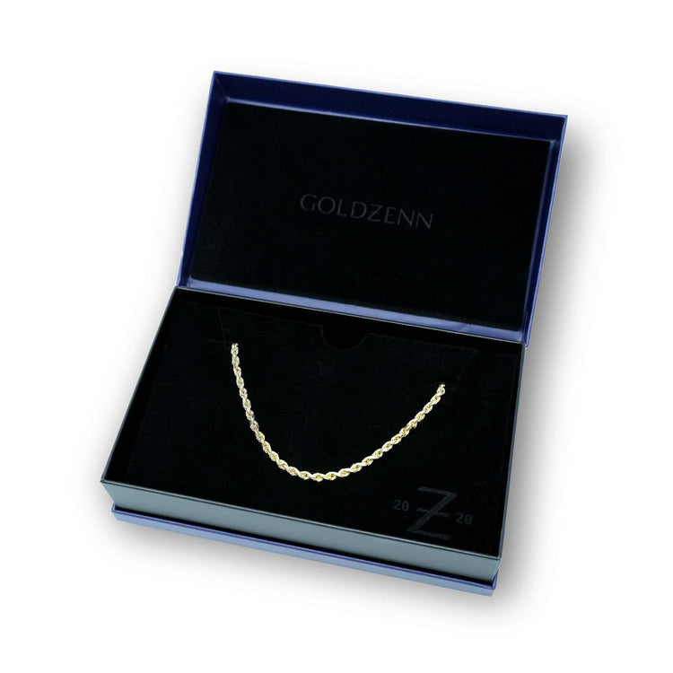 A Rope Chain - 2mm-5mm Hollow Yellow Gold necklace is displayed in an open black velvet-lined box, featuring the GOLDZENN brand name printed on the inside lid.