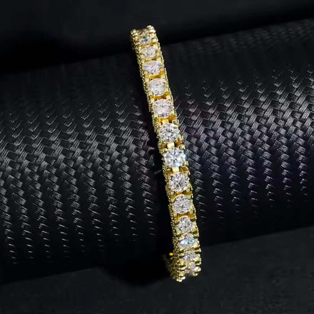 The Iced Out Moissanite Tennis Bracelet - 5mm, crafted in 925 sterling silver with large round gems, sparkles brilliantly on a textured black surface.