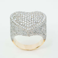 The Iced-Out Heart Cluster Ring 5.46 CT Diamond in 14k yellow gold features a wide band fully encrusted with sparkling white diamonds and a heart-shaped cluster on top, set against a plain white background.