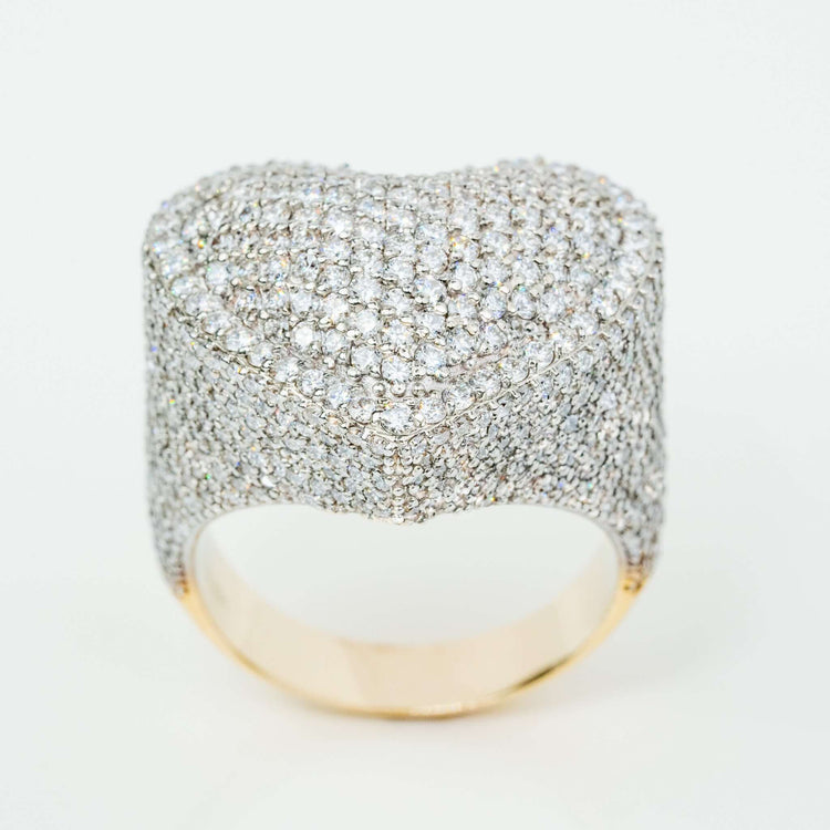 The Iced-Out Heart Cluster Ring 5.46 CT Diamond in 14k yellow gold features a wide band fully encrusted with sparkling white diamonds and a heart-shaped cluster on top, set against a plain white background.