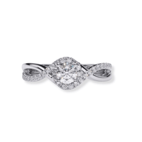 The Infinity Halo Lab Diamond Engagement Ring features a round, brilliant-cut center lab diamond set in white gold, with an infinity halo and a twisted band adorned with accent diamonds.