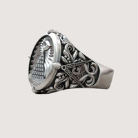 The Masonic All-Seeing Eye Pyramid Illuminati Ring is a silver ring engraved with a pyramid and All-Seeing Eye, surrounded by ornate leaf motifs and classic Masonic symbols on the sides.