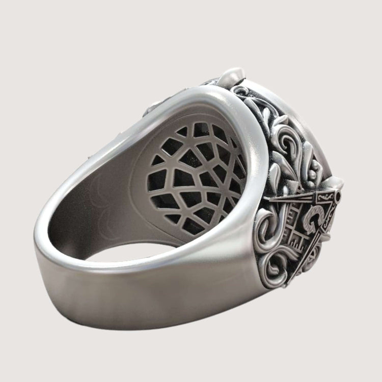 The Masonic All-Seeing Eye Pyramid Illuminati Ring features intricate, raised scrollwork and shield-like designs on the sides, shown from an angled side view against a plain light background.