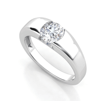 A men’s wedding band with a wide silver band features a 3 carat round-cut lab-grown diamond centerpiece set in a modern half-bezel style.