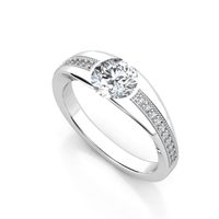 The Men's Wedding Band – 3 Carat Diamond Masterpiece features a large round center diamond and small accent diamonds on both sides, elegantly set in white gold and displayed on a white background.