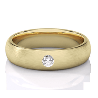 A matte yellow gold men's wedding band, 5mm wide, with a lab grown diamond set at the center, displayed on a white surface.