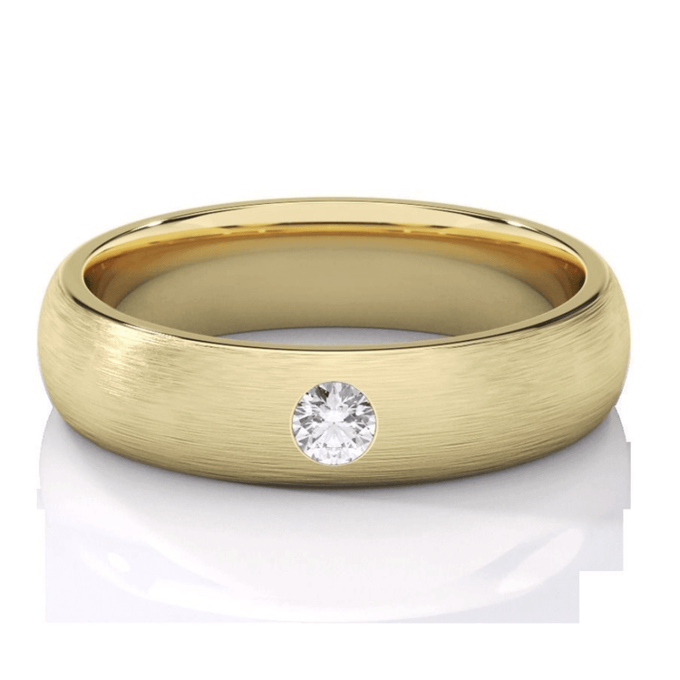A matte yellow gold men's wedding band, 5mm wide, with a lab grown diamond set at the center, displayed on a white surface.