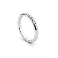 The Men's Wedding Band White Gold Lab Grown Diamond Eternity features five small round lab-grown diamonds set in rectangular segments along a slim white gold band, photographed on a white background with a subtle shadow.