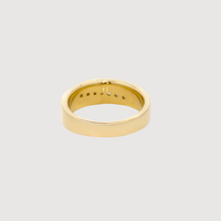 A men's wedding ring in 14k yellow gold with multiple diamonds, polished finish, and slightly rounded edges, displayed against a light gray background.