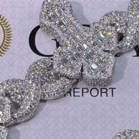 A close-up of the Moissanite Cross Bracelet, crafted from 925 sterling silver, sparkles with numerous stones. Displayed on a paper marked “REPORT” against a faint patterned background.