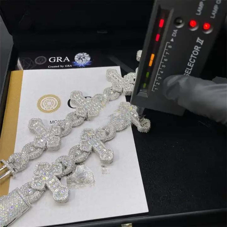 A gloved hand uses a diamond tester on two Moissanite Cross Bracelet – 925 Sterling Silver, sparkling atop official certificates in a black box. The tester’s lights are illuminated, indicating a reading.