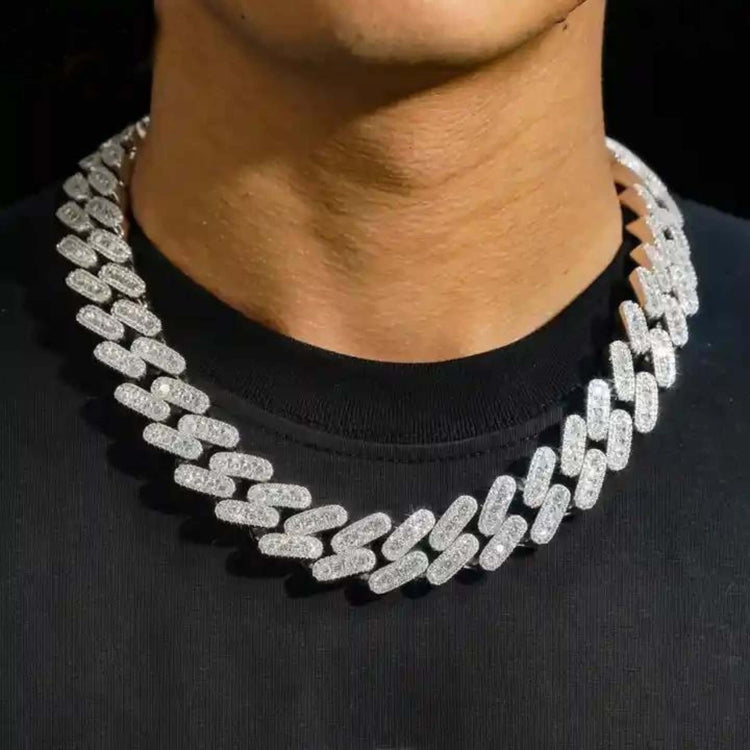 Someone wearing the Moissanite Cuban Link Chain (12mm-15mm) in 925 Sterling Silver around their neck.