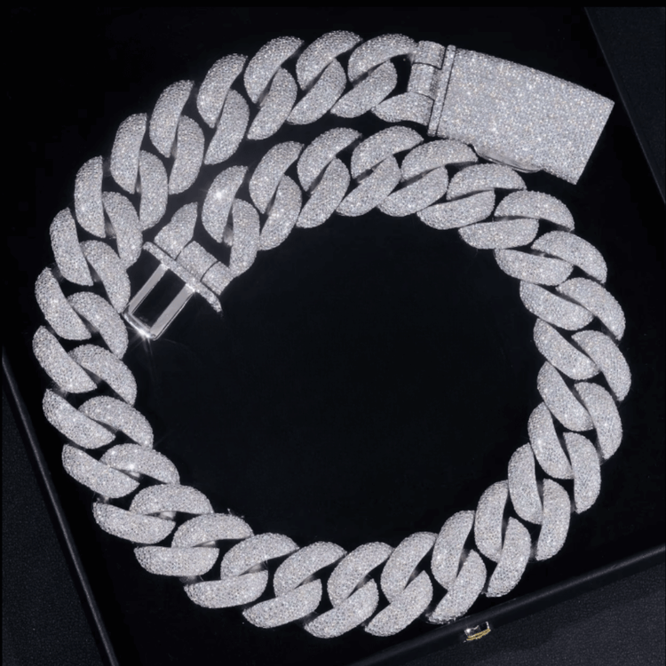 The Moissanite Cuban Links Chain 25mm, made from 925 sterling silver and adorned with sparkling stones, is arranged in a circular shape against a black background.