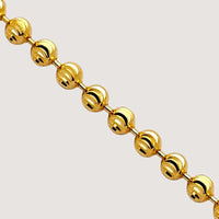 The Moon Cut Bead Chain-2mm features polished 2mm spherical beads evenly spaced and connected by small gold links, displayed diagonally against a light background.