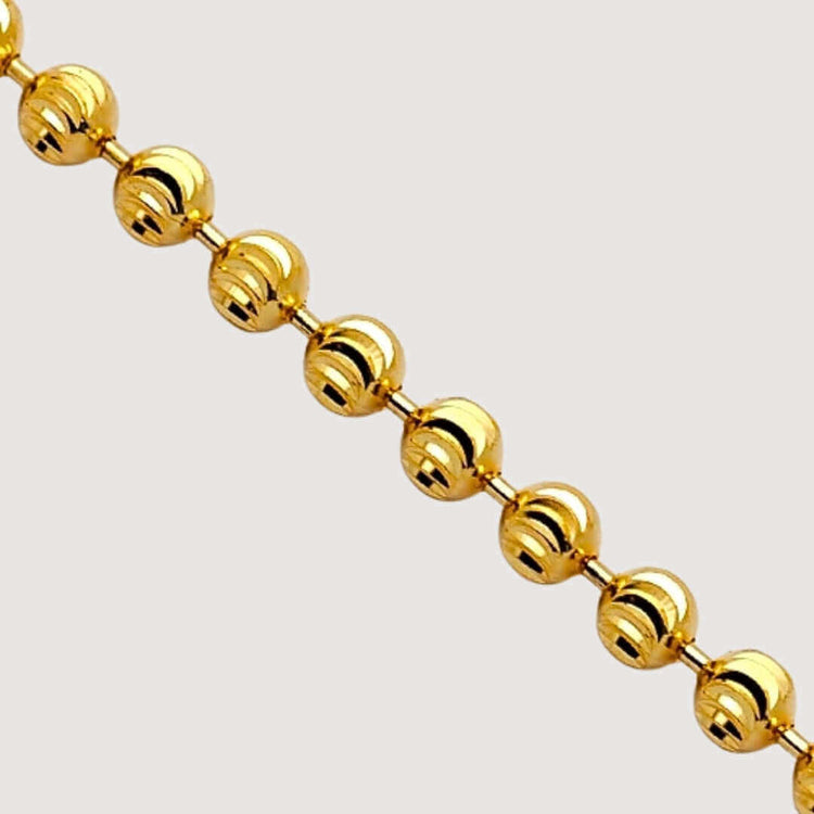 The Moon Cut Bead Chain-2mm features polished 2mm spherical beads evenly spaced and connected by small gold links, displayed diagonally against a light background.
