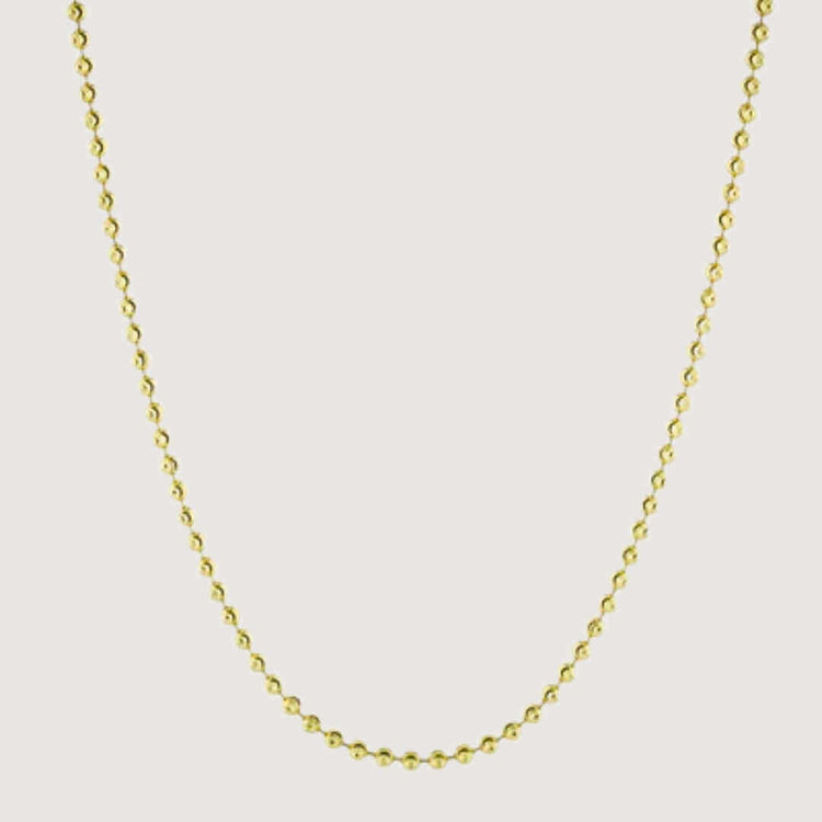The Moon Cut Bead Chain-2mm features evenly spaced small round beads along a solid gold chain, displayed on a plain light background.