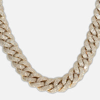 A close-up of the Natural Diamond Cuban Link Chain - 13mm, crafted in 10k solid gold and encrusted with natural diamonds, displayed against a plain white background.