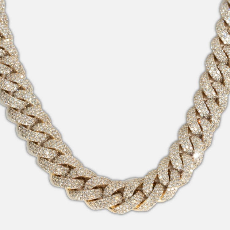 A close-up of the Natural Diamond Cuban Link Chain - 13mm, crafted in 10k solid gold and encrusted with natural diamonds, displayed against a plain white background.