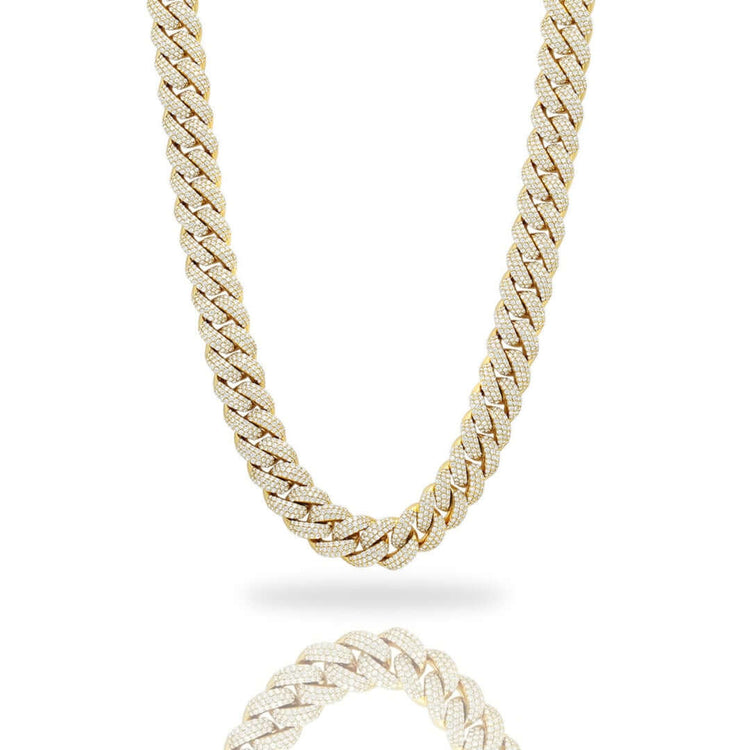 The Natural Diamond Cuban Link Chain - 13mm is a 10k solid gold necklace, encrusted with small, sparkling natural diamonds, displayed on a white background with a subtle reflection underneath.