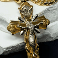 A close-up of the Orthodox Cross Pendant - 14K Gold, featuring Jesus on the cross with detailed craftsmanship and Cyrillic letters, displayed on a white surface.
