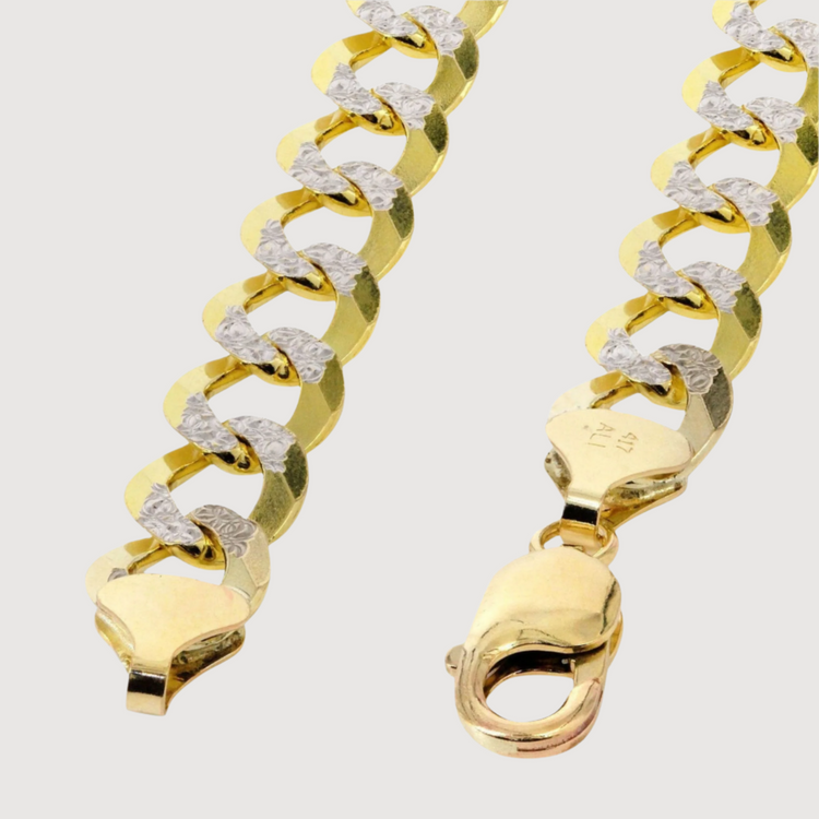 A close-up of the Pavé Curb Link Chain, available in 7mm to 13mm solid yellow gold, highlights the intricate details and luxurious design of this premium accessory.
