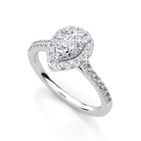 The Pear-Shaped Halo Lab Diamond Engagement Ring with Pavé Band features a pear-shaped lab diamond center, a halo of smaller diamonds, and extra pavé accents on a slim, polished white metal band.