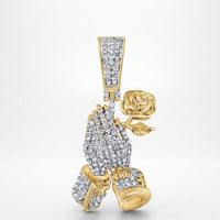 The Diamond Praying Hands Rose Charm 1/2CT 10K Gold features two hands holding a rose, all encrusted with diamonds. This pendant shines luxuriously in yellow gold against a plain white background.