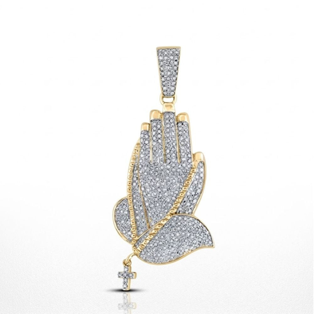 The Diamond Prayer Hands Pendant 7/8CT 10K Gold features two hands in prayer adorned with diamonds, a rosary draped over them, and a small cross hanging at the end—a stunning 10K gold diamond charm.