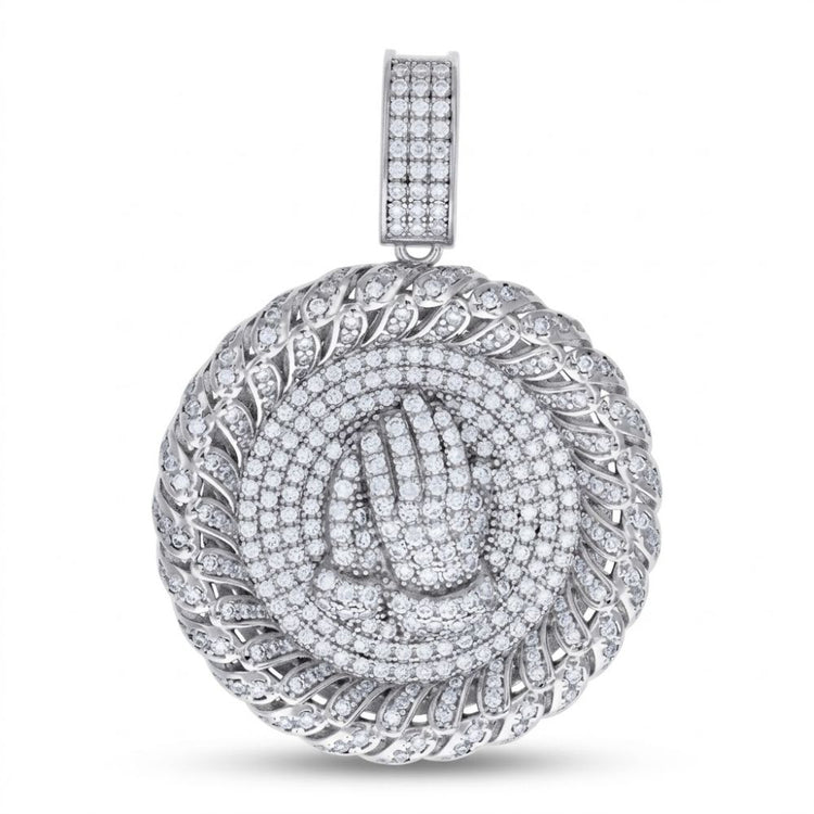 The Sterling Silver Moissanite Praying Hands Pendant features a round 925 sterling silver design with sparkling moissanite stones and a detailed praying hands motif at the center.