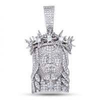 The 925 Silver Men Moissanite Jesus Pendant features a detailed face with a beard, long hair, and spiked crown, all sparkling with moissanite stones—creating a striking religious statement against a plain white background.