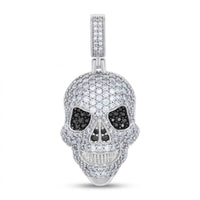 The Sterling Silver Black White Moissanite Skull Pendant features sparkling moissanite stones with black accents for the eyes and nose, detailed teeth, and a bold men’s style, showcased against a plain white background.