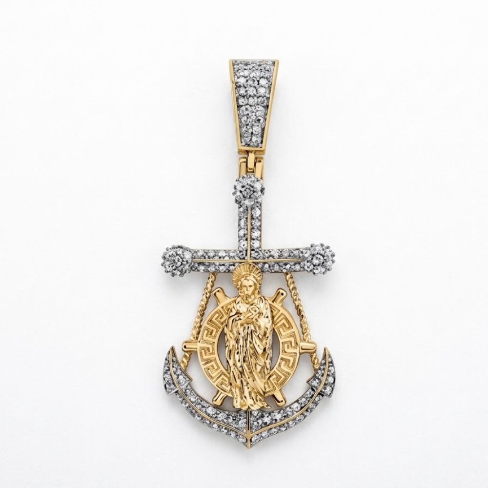 The Diamond Cross Anchor Charm 5/8CT 10K Gold features a striking anchor pendant with diamond accents, intricate patterns, and a detailed woman figure, all set in yellow gold with a diamond-studded bail against a white background.