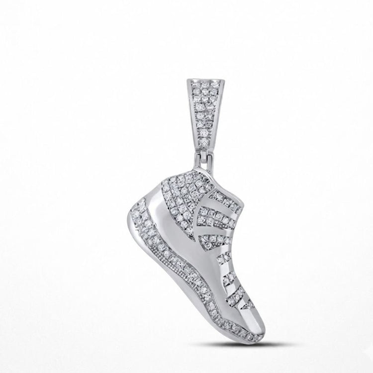 The Sterling Silver Diamond Shoe Pendant 1/2 CTW, designed like a sneaker and set with dazzling diamonds, shines as bold fashion jewelry against a plain white background.