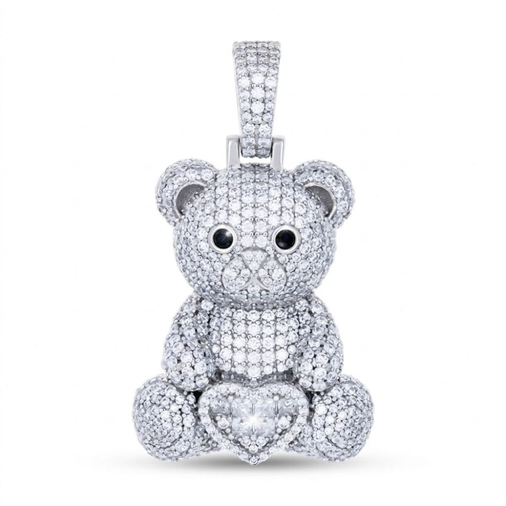The Sterling Silver Moissanite Teddy Bear Heart Pendant features black and white moissanite eyes, a heart-shaped diamond at the base, and sparkling diamonds, set in sterling silver against a plain white background.