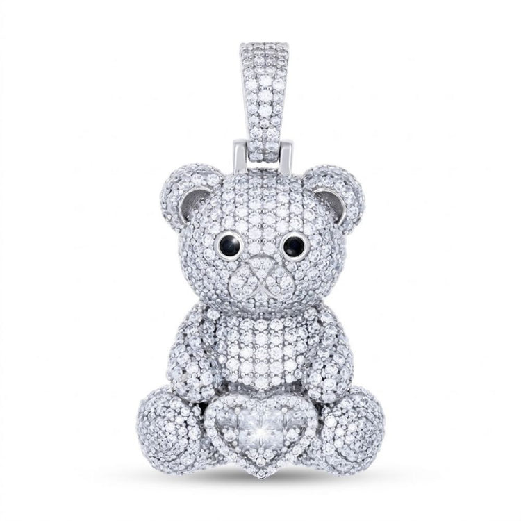 The Sterling Silver Moissanite Teddy Bear Heart Pendant features black and white moissanite eyes, a heart-shaped diamond at the base, and sparkling diamonds, set in sterling silver against a plain white background.