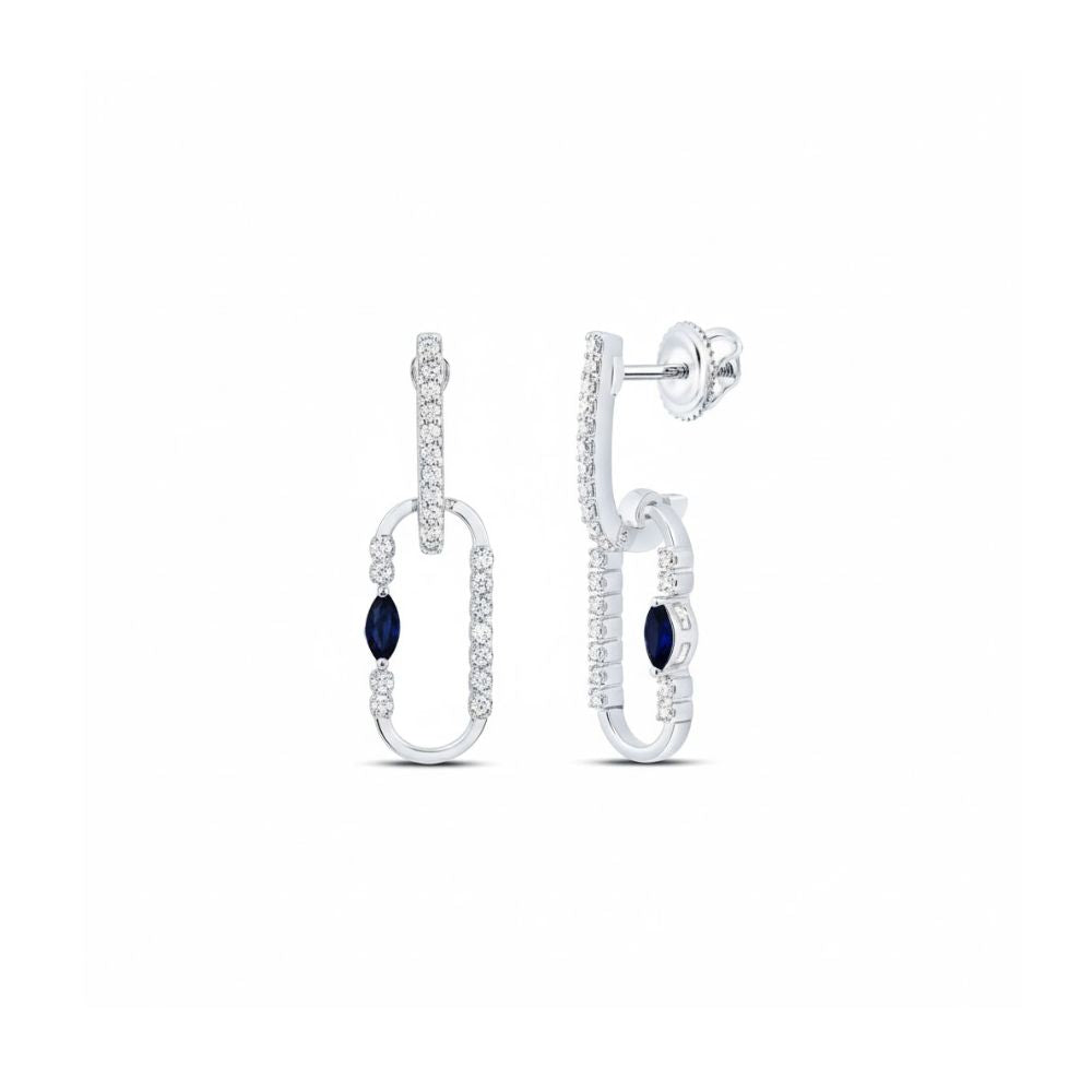 A pair of 14K white gold diamond paper clip dangle earrings featuring oval-shaped hoops with small clear stones and a single dark blue marquise stone on each earring.