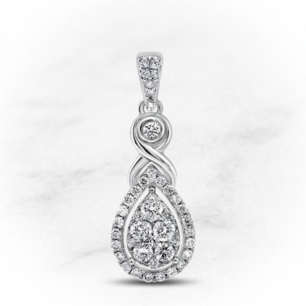 The 10K White Gold 1/2 CTW Diamond Cluster Pendant showcases an infinity symbol above a teardrop setting, both adorned with round diamonds, creating an elegant look against a light marbled background.