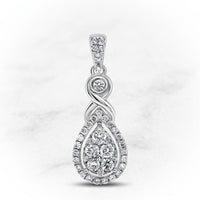 The 10K White Gold 1/2 CTW Diamond Cluster Pendant showcases an infinity symbol above a teardrop setting, both adorned with round diamonds, creating an elegant look against a light marbled background.