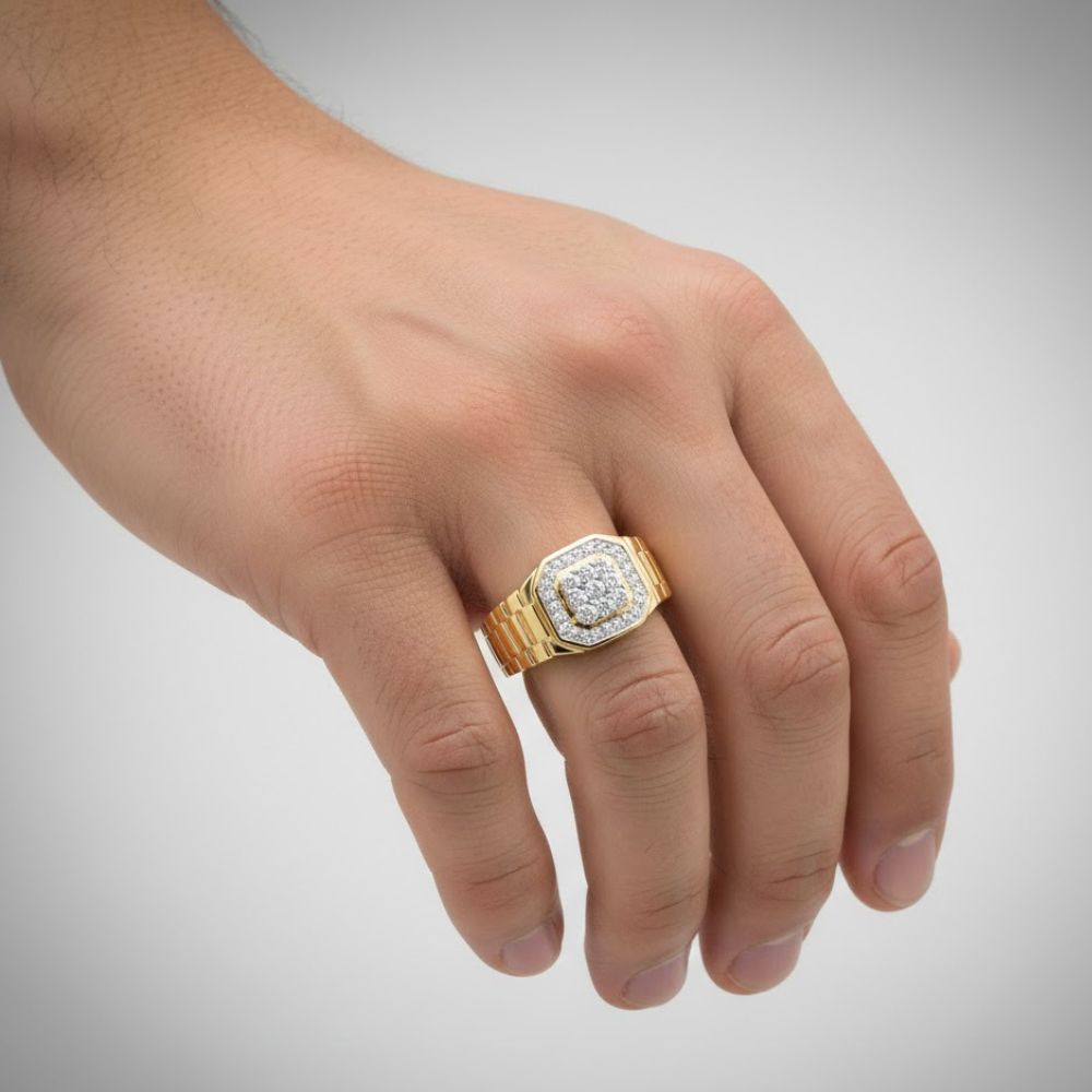 A hand wears the 1/4CTW Natural Diamond Men’s Ring in 10k gold, featuring a square face with natural diamonds, displayed against a plain light gray background.