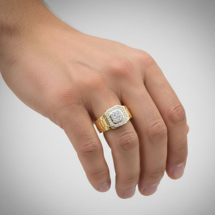 A hand wears the 1/4CTW Natural Diamond Men’s Ring in 10k gold, featuring a square face with natural diamonds, displayed against a plain light gray background.