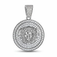 The Moissanite Medusa Egyptian Charm Pendant features a round sterling silver design with a raised classical face and flowing hair, accented by sparkling moissanite stones on both the pendant and bail for added brilliance.