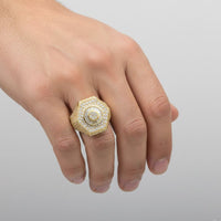 A hand wearing the Round Cluster Gold Ring, crafted in 10K gold and adorned with sparkling CZ stones, shines brilliantly against a plain light background.