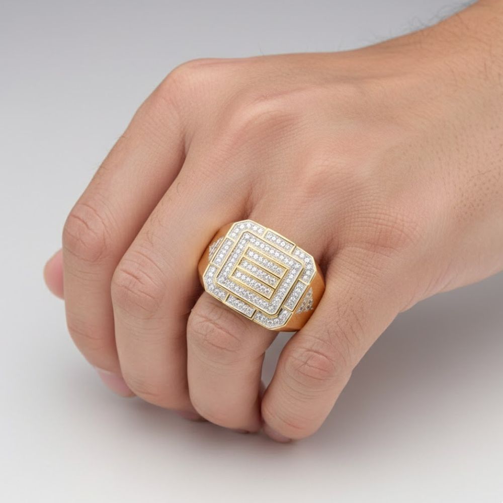 A hand wears the 10k Yellow Gold Diamond Cluster Ring 1/3 Cttw, featuring a geometric layered square design with sparkling diamonds, set against a plain light background.