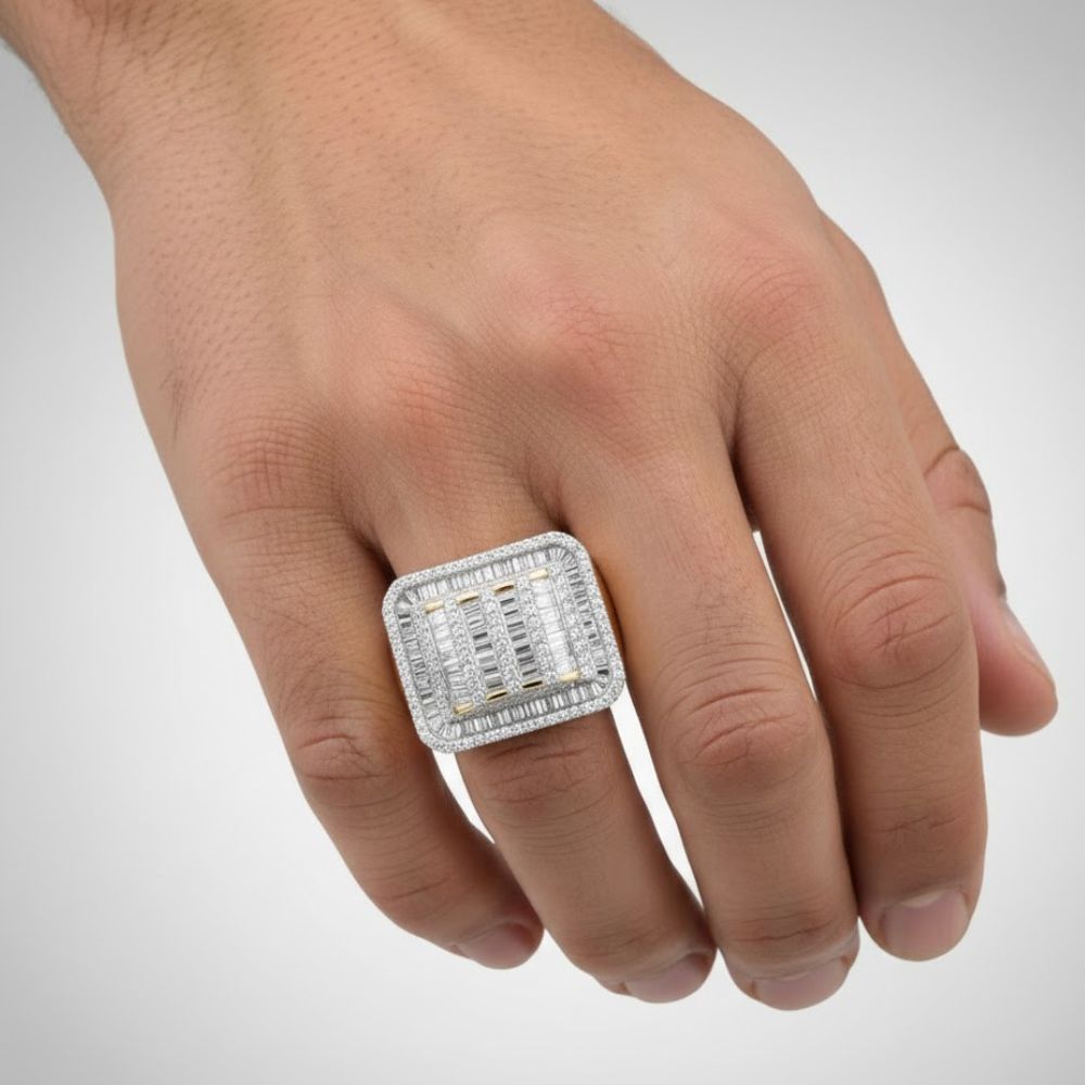 A hand wears the 10k Yellow Gold Baguette Diamond Rectangle Ring on the ring finger, its unique design creating a bold fashion statement against a plain background.