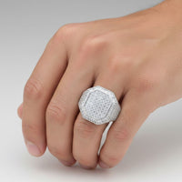A hand displays the Round Moissanite Octagon Head Fashion Ring, featuring a striking octagon-shaped silver band set with multiple sparkling moissanite stones against a plain light background.