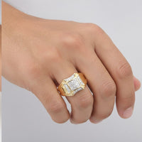 A hand adorned with a 10K Yellow Gold Diamond Cluster Ring 1/4CT, showcasing sparkling diamonds in square and rectangular settings against a plain, light-colored background.
