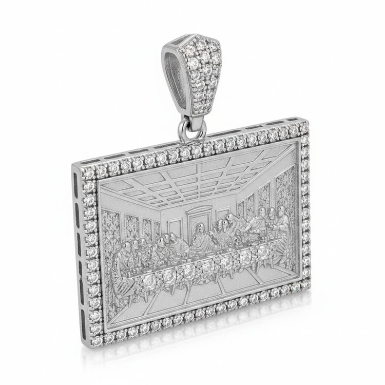 A rectangular sterling silver pendant features an engraved Last Supper, bordered by sparkling stones and an embellished bail—a striking piece of faith jewelry called the Baguette Round Moissanite Last Supper.