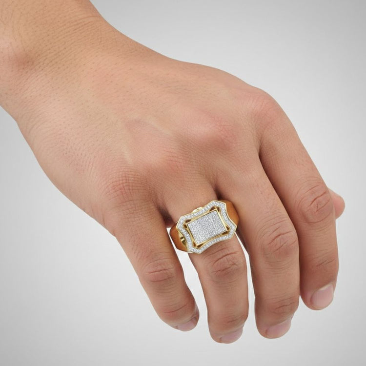 A hand wears the 10k Yellow Gold Diamond Curved Octagon Ring (1/3 Cttw) on the ring finger, showcased against a plain light gray background.