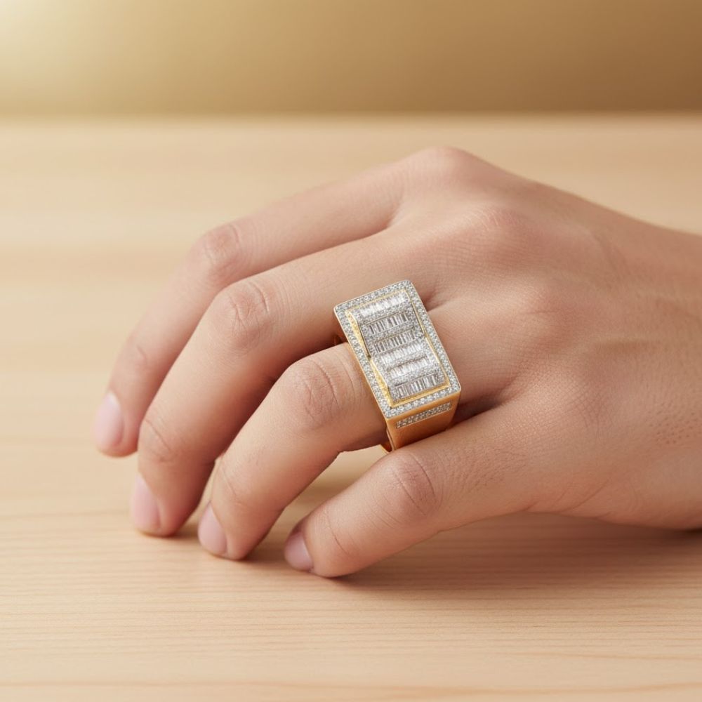 A hand displays the 0.73 CTW Natural Diamond Cluster Ring in 14k yellow gold, set with natural diamonds, on a light wooden surface against a blurred golden background.